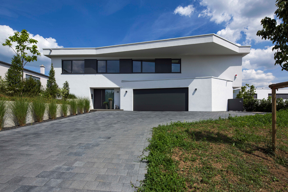 White contemporary two floor render detached house in Stuttgart with a flat roof.