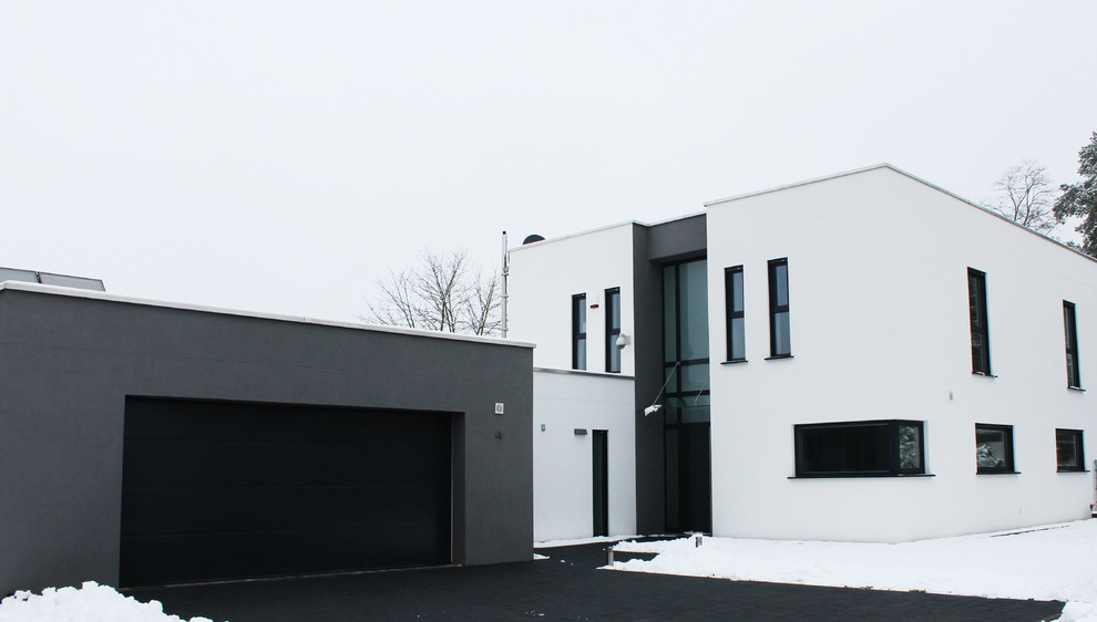 Design ideas for a white and medium sized contemporary two floor render house exterior in Other with a flat roof.