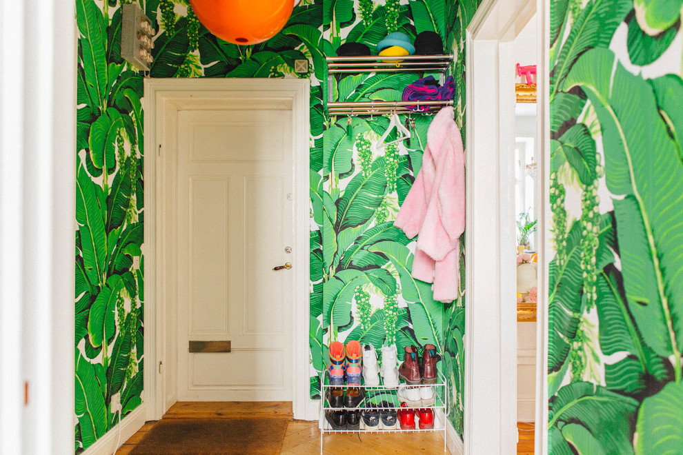 Hallway - mid-sized eclectic medium tone wood floor hallway idea in Stockholm with green walls