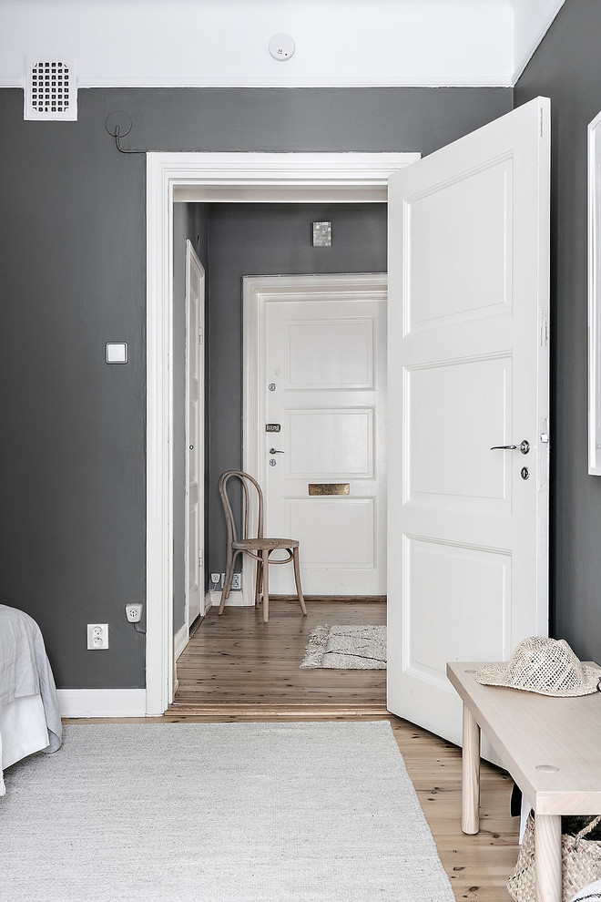 Mid-sized danish light wood floor hallway photo in Stockholm with gray walls