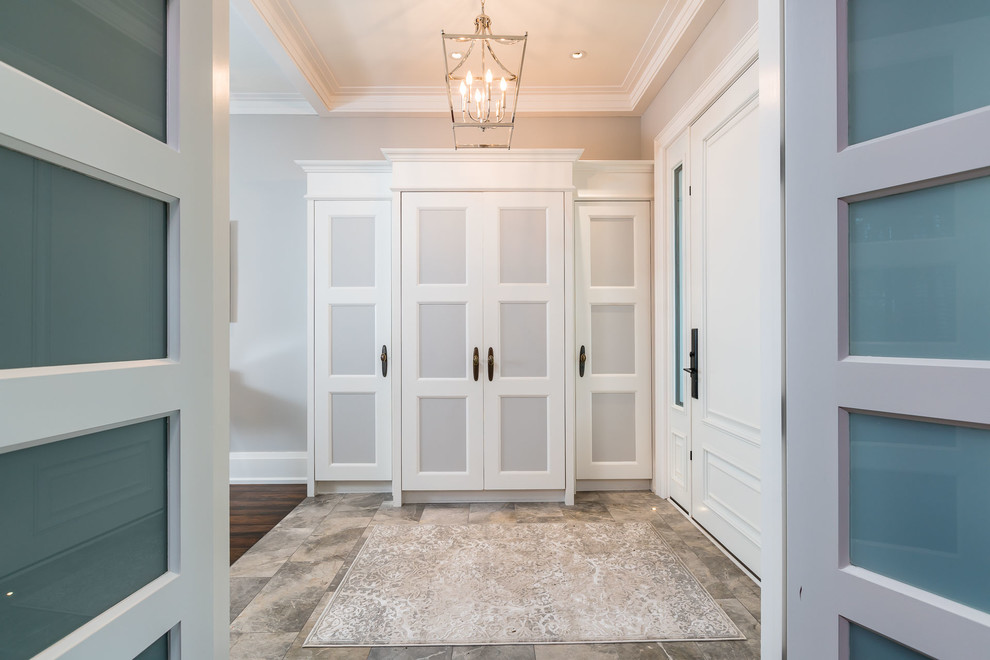 Inspiration for a mid-sized transitional brown floor hallway remodel in Toronto with gray walls