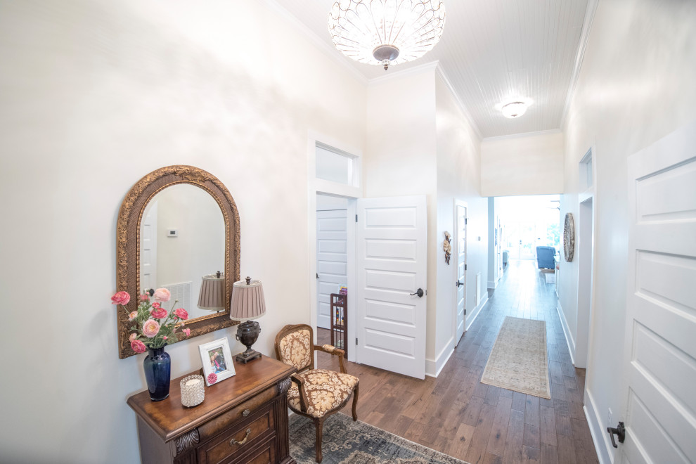 Inspiration for a large timeless dark wood floor, brown floor and wood ceiling hallway remodel in Atlanta with white walls