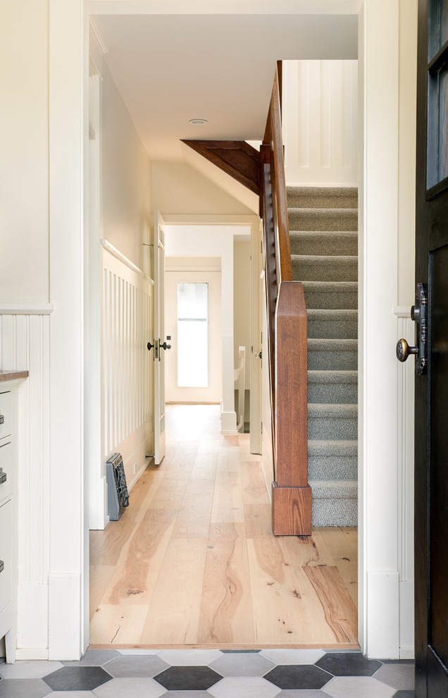 Inspiration for a small timeless light wood floor and beige floor hallway remodel in Calgary with white walls