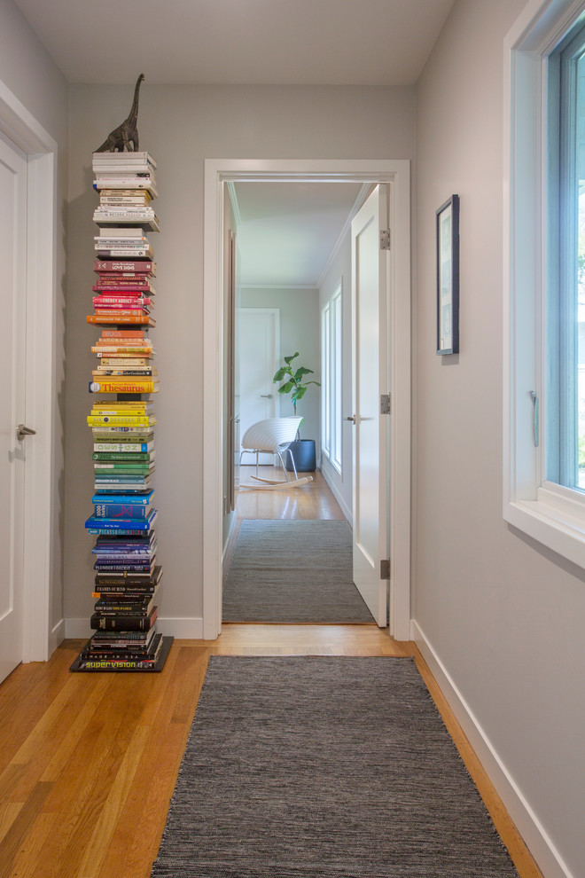 Example of a transitional medium tone wood floor and brown floor hallway design in San Francisco with gray walls