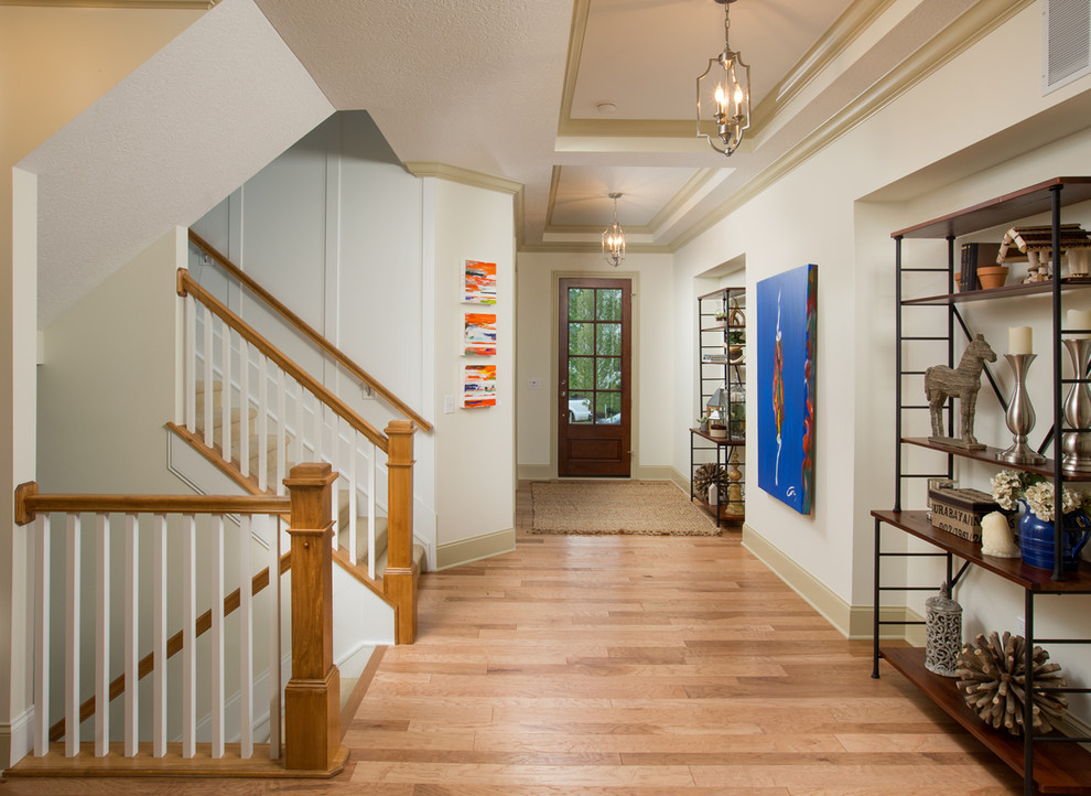 Example of a large classic light wood floor hallway design in Columbus with white walls