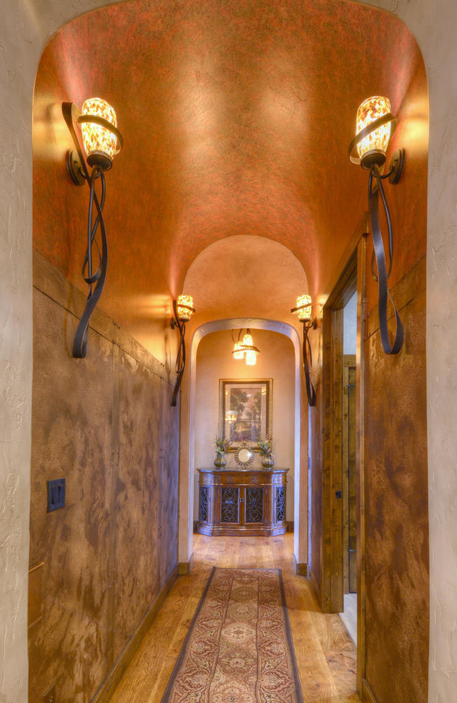 Inspiration for a huge mediterranean medium tone wood floor hallway remodel in Denver with brown walls