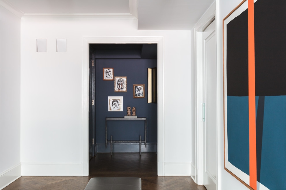 Hallway - small traditional dark wood floor and brown floor hallway idea in New York with blue walls