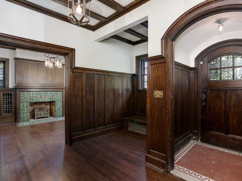 Mid-sized elegant dark wood floor and brown floor hallway photo in Detroit with white walls