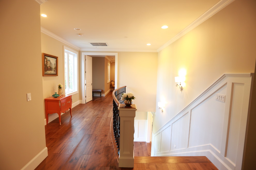 Hallway - mid-sized traditional medium tone wood floor and brown floor hallway idea in Seattle with beige walls