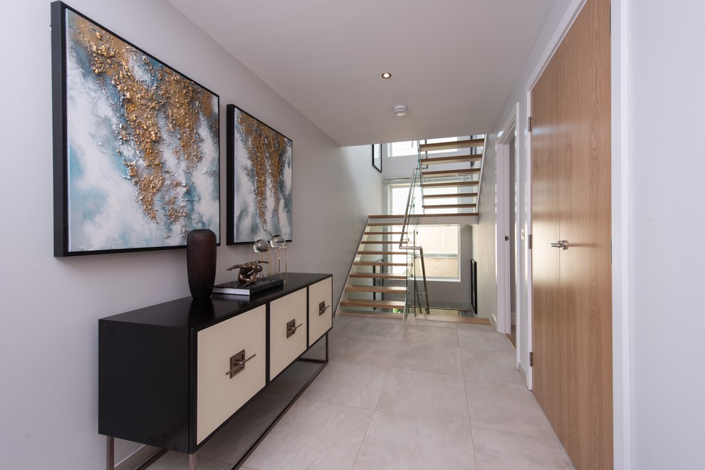 Mid-sized trendy porcelain tile hallway photo in London with white walls
