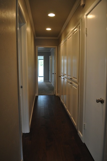 Mid-sized elegant dark wood floor hallway photo in Oklahoma City with beige walls