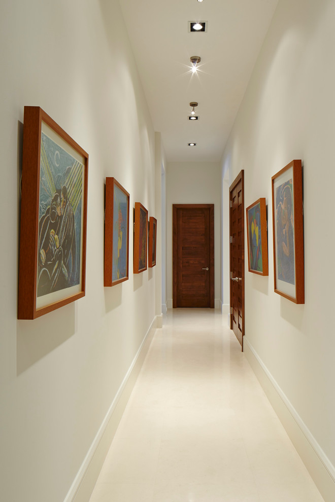 Hallway - huge contemporary porcelain tile hallway idea in Miami with white walls