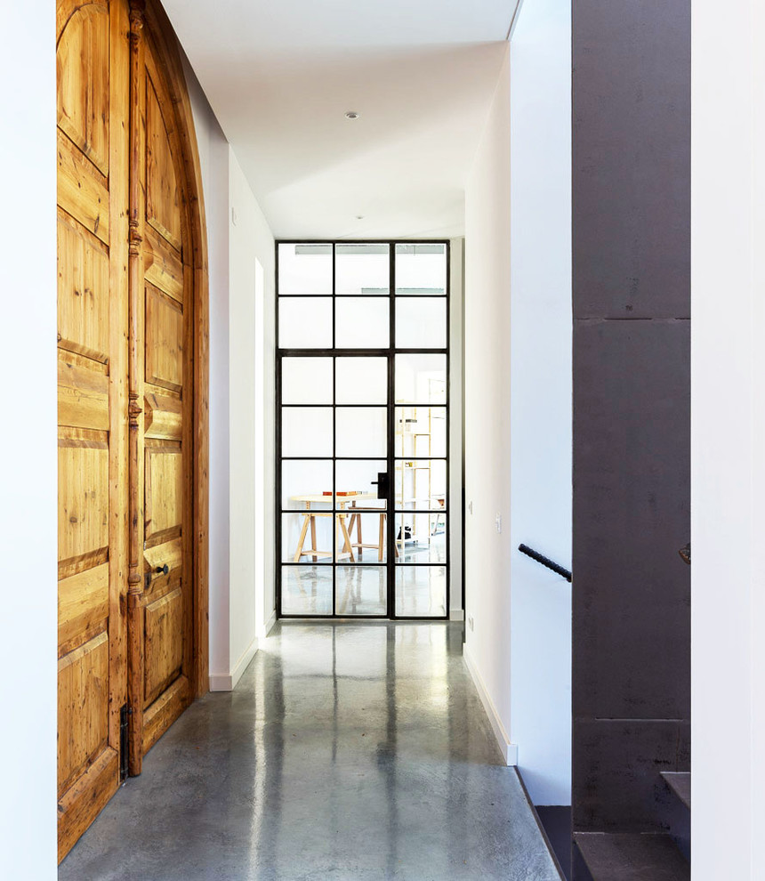 Inspiration for a mid-sized mediterranean concrete floor hallway remodel in Barcelona with white walls