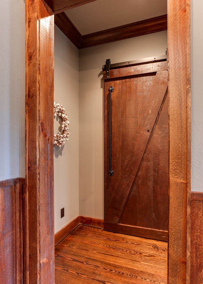 Example of a large farmhouse hallway design in Raleigh with gray walls