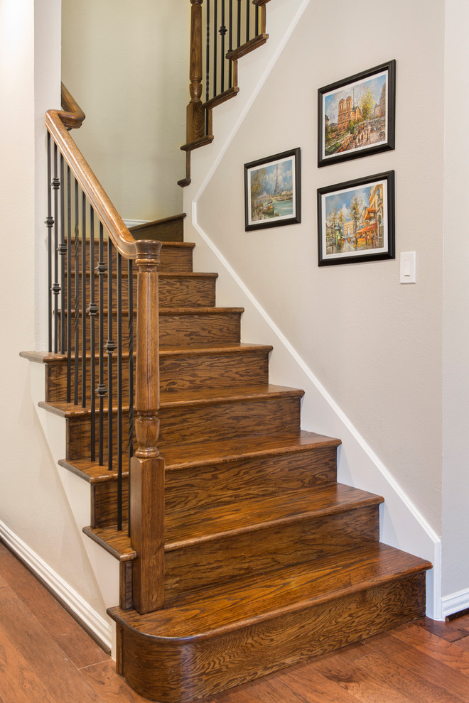 Example of a large transitional staircase design in Other