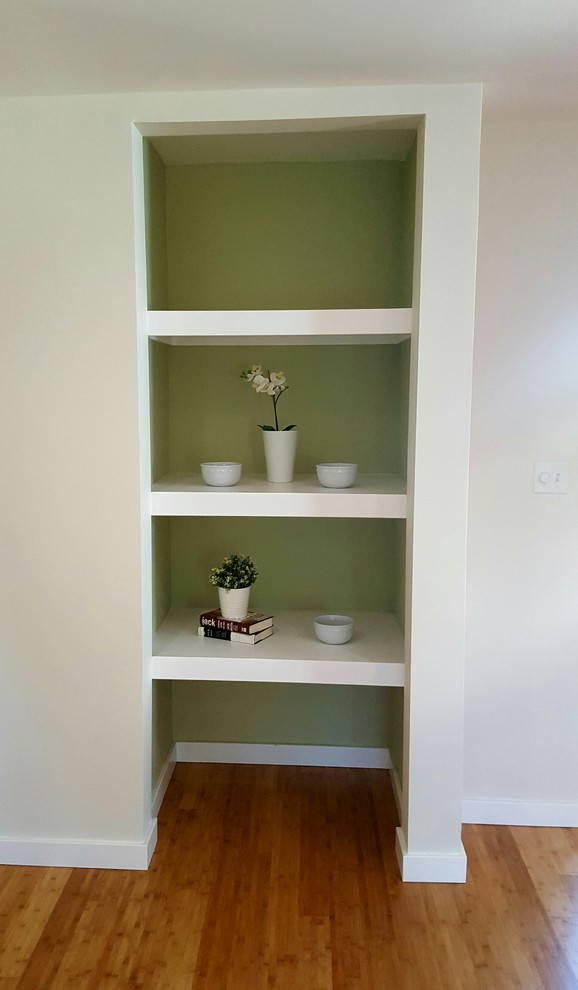 Hallway - country bamboo floor and brown floor hallway idea in Los Angeles with green walls