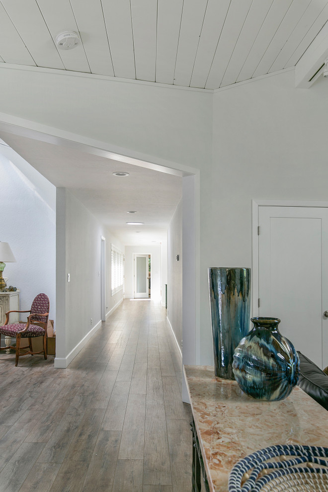 Example of a large trendy gray floor and vinyl floor hallway design in San Francisco with white walls