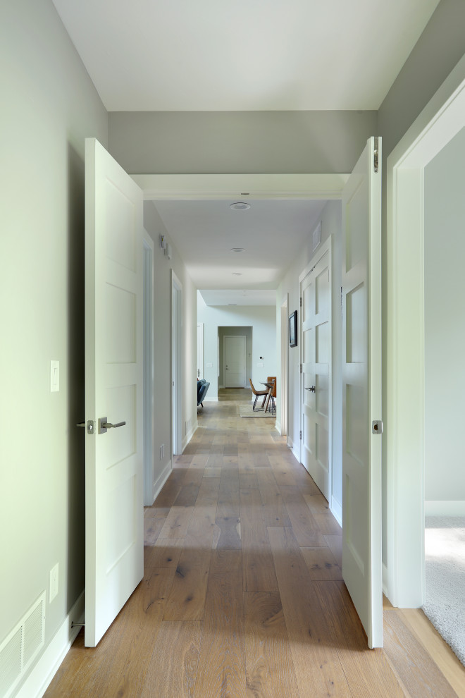 Inspiration for a mid-sized country light wood floor hallway remodel in Grand Rapids with gray walls
