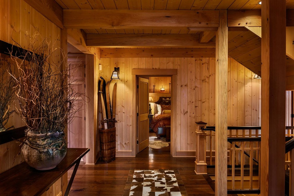 Hallway - large rustic dark wood floor hallway idea in Portland Maine with brown walls