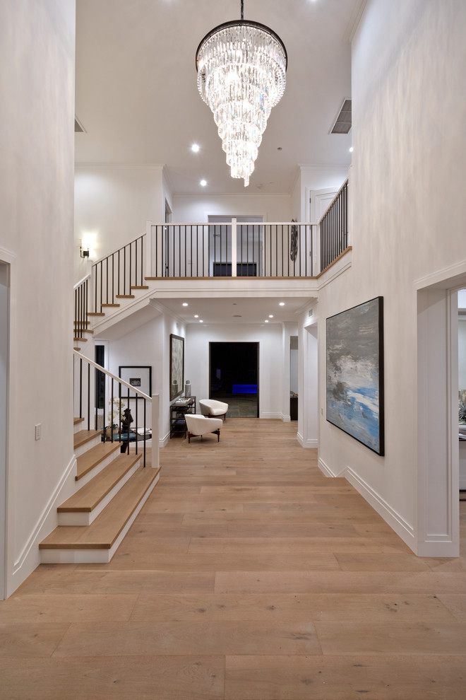 Inspiration for a huge transitional medium tone wood floor and brown floor hallway remodel in Los Angeles with white walls