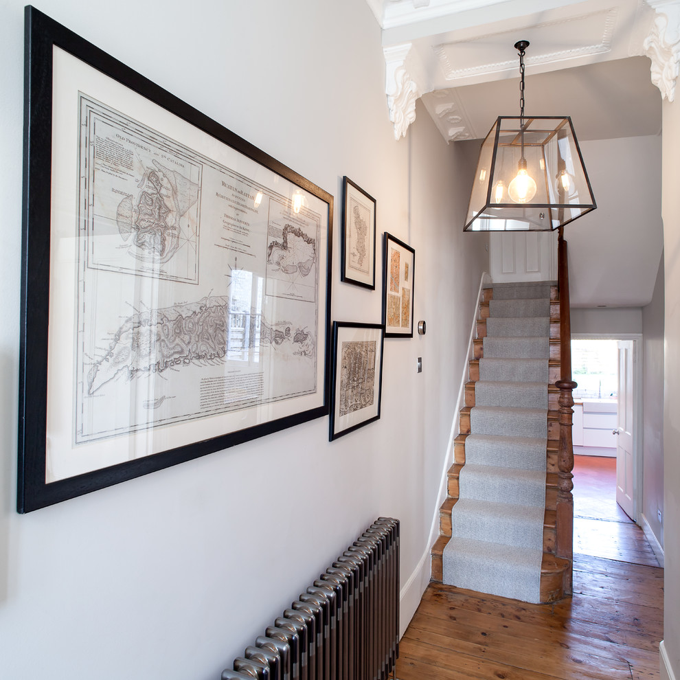 Hallway - mid-sized contemporary dark wood floor and brown floor hallway idea in London with gray walls