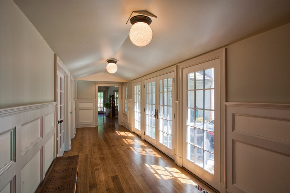 Large cottage medium tone wood floor hallway photo in Bridgeport with green walls