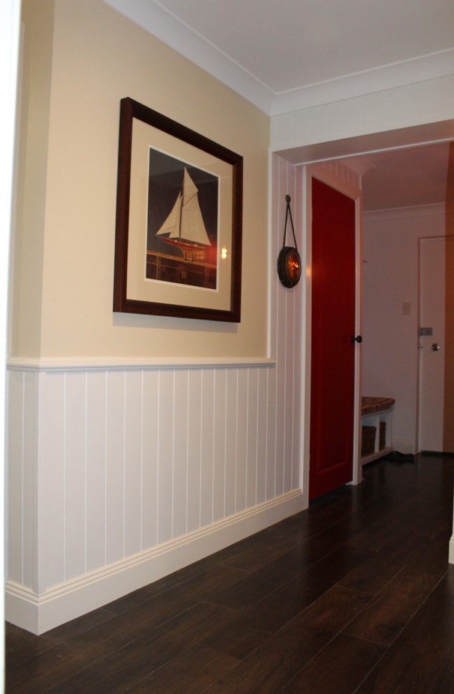 Hallway - small coastal dark wood floor and brown floor hallway idea in Brisbane with white walls