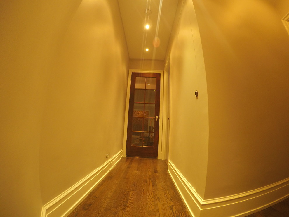 Foto de recibidores y pasillos minimalistas de tamaño medio con paredes beige y suelo de madera clara