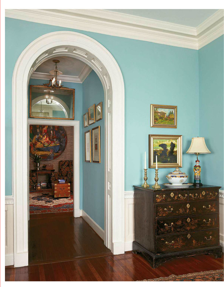 Inspiration pour un grand couloir traditionnel avec un mur bleu et un sol en bois brun.