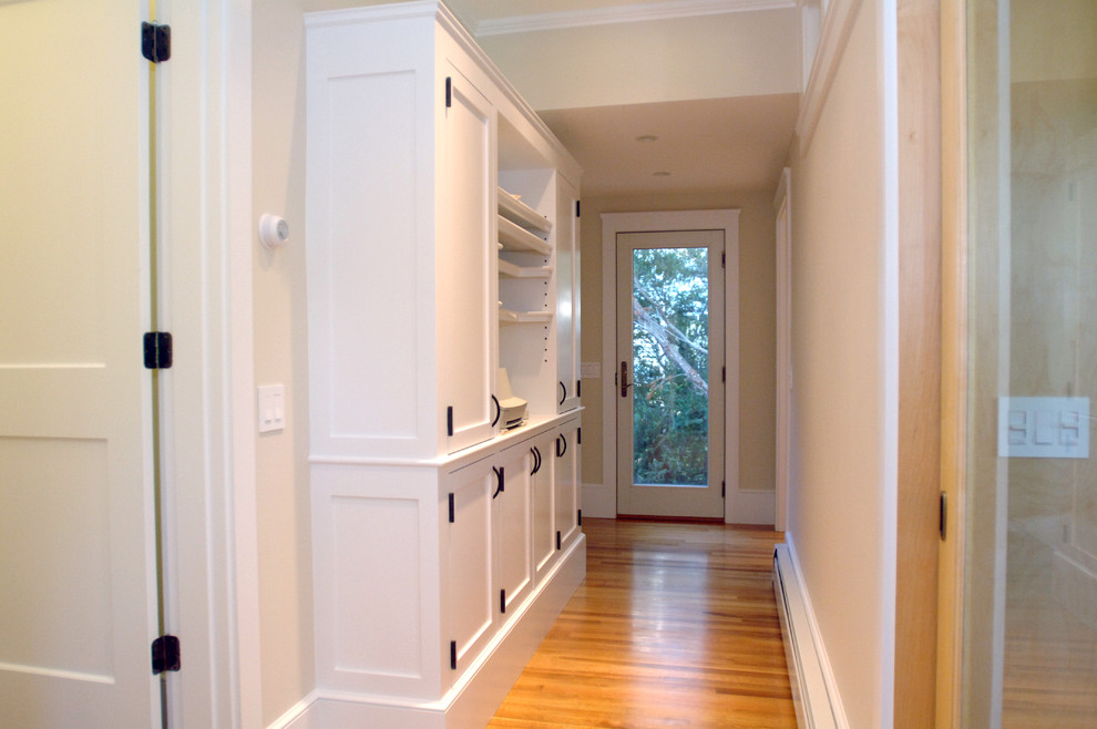 Mid-sized elegant light wood floor and brown floor hallway photo in Boston with beige walls