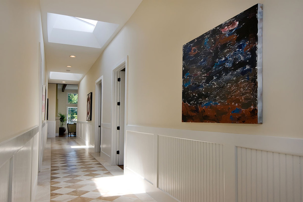 Idées déco pour un couloir contemporain avec un mur beige, un sol en marbre et un sol multicolore.