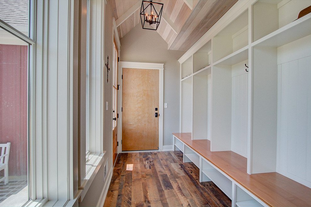 Cottage light wood floor and brown floor hallway photo in Milwaukee with white walls