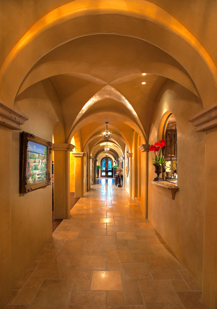 Стильный дизайн: огромный коридор в средиземноморском стиле с разноцветными стенами, полом из травертина и разноцветным полом - последний тренд