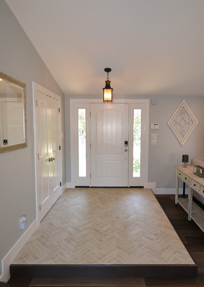 Large transitional medium tone wood floor and brown floor hallway photo in Philadelphia with gray walls