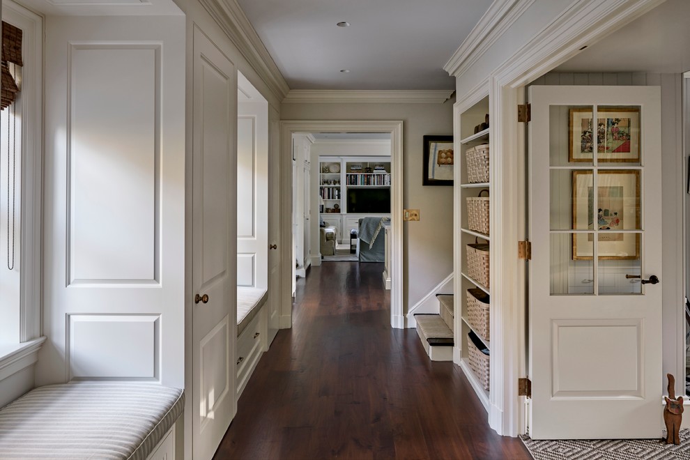 Example of a mid-sized classic dark wood floor hallway design in New York with beige walls