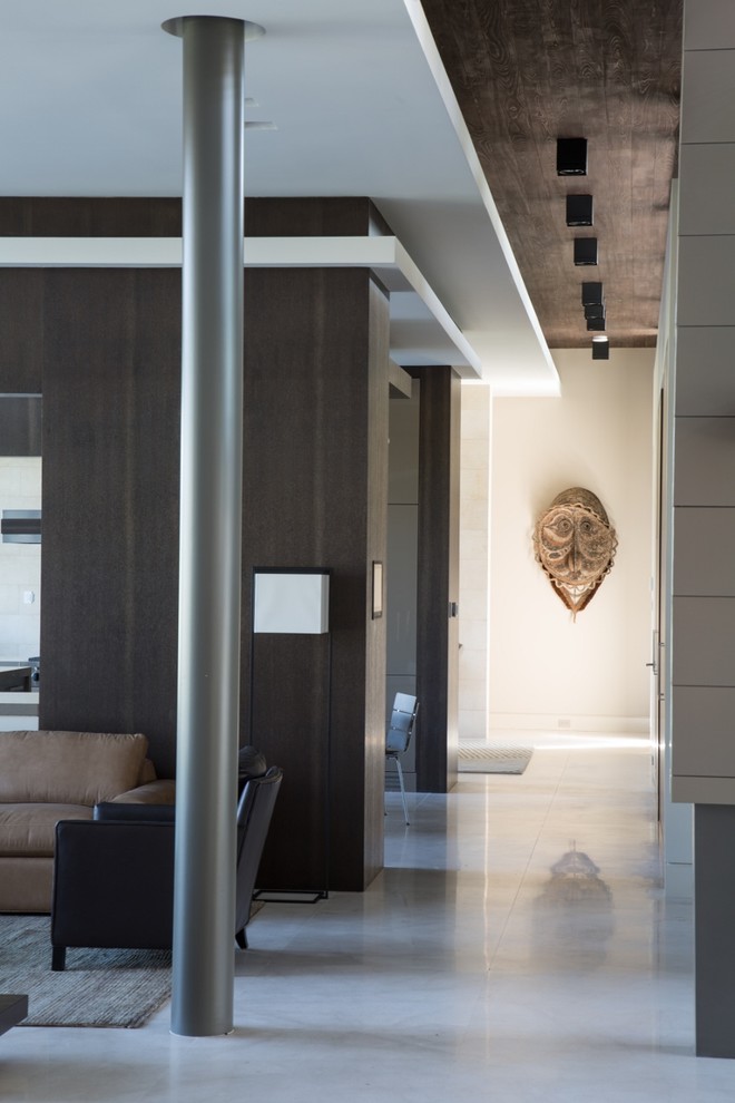 Example of a large minimalist limestone floor and gray floor hallway design in Miami with beige walls