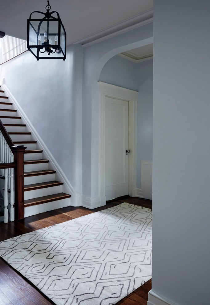 Example of a mid-sized classic carpeted hallway design in New York with blue walls