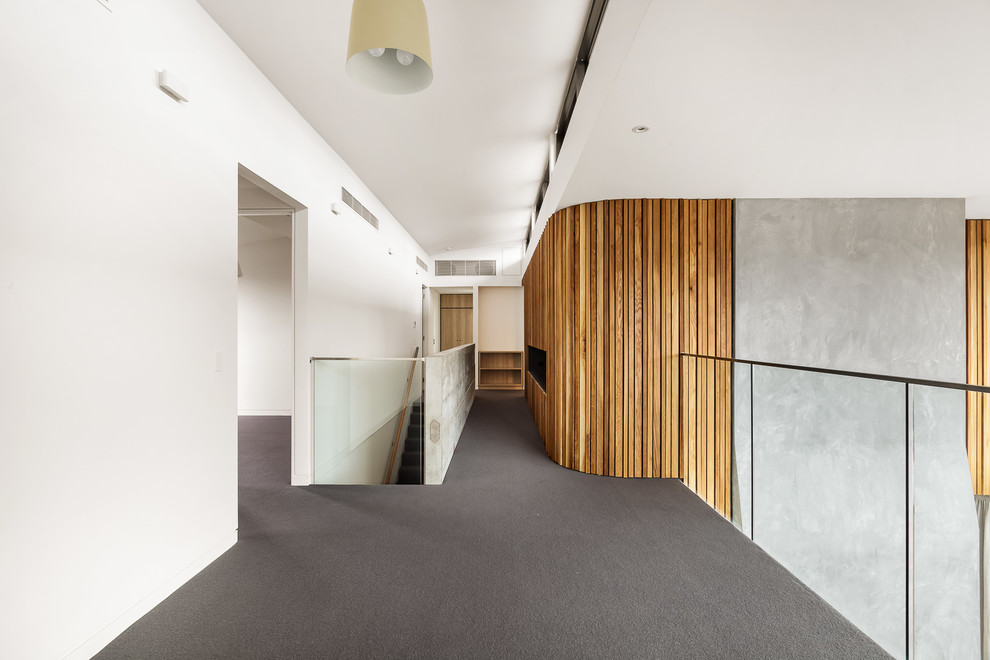 Foto di un ingresso o corridoio minimalista con pareti grigie, moquette e pavimento grigio