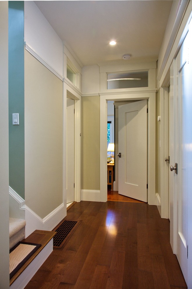 Idées déco pour un grand couloir contemporain avec un mur beige, parquet foncé et un sol marron.