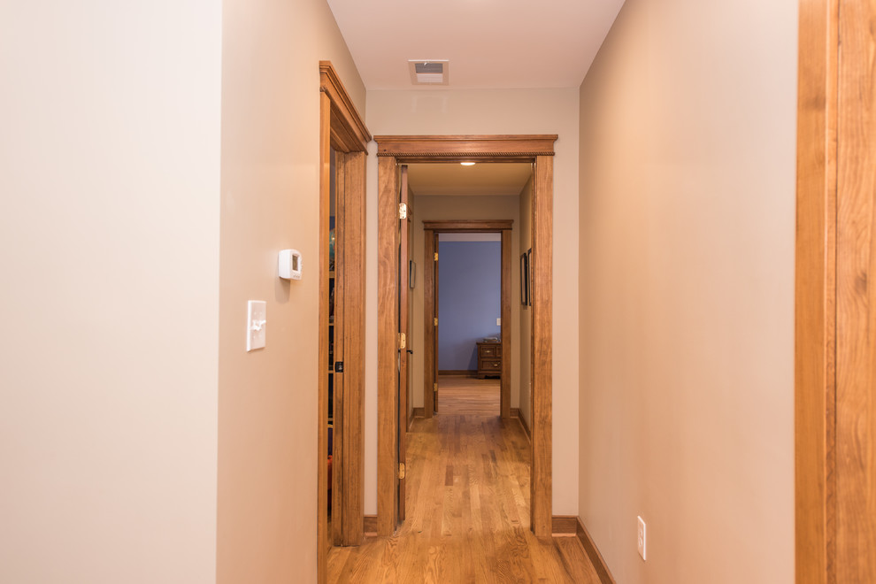 Inspiration for a mid-sized craftsman light wood floor and brown floor hallway remodel in DC Metro with beige walls