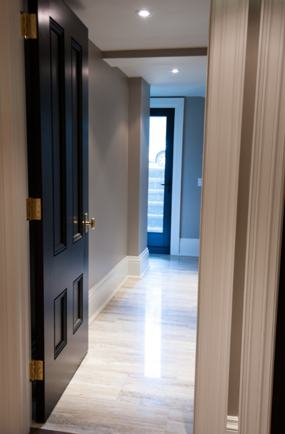 Foto di un grande ingresso o corridoio minimal con pareti marroni, pavimento in legno massello medio e pavimento bianco