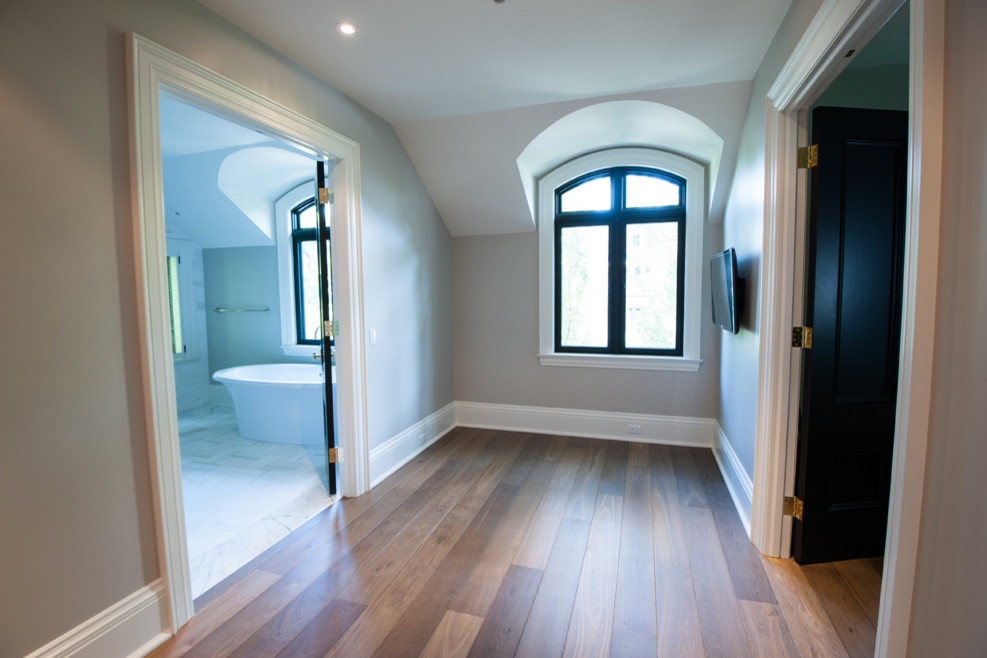 Inspiration for a large contemporary medium tone wood floor hallway remodel in Toronto with brown walls