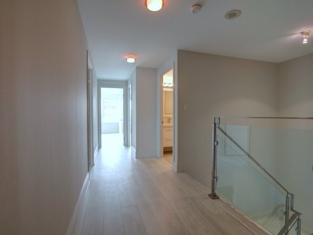 Hallway - contemporary light wood floor hallway idea in Toronto