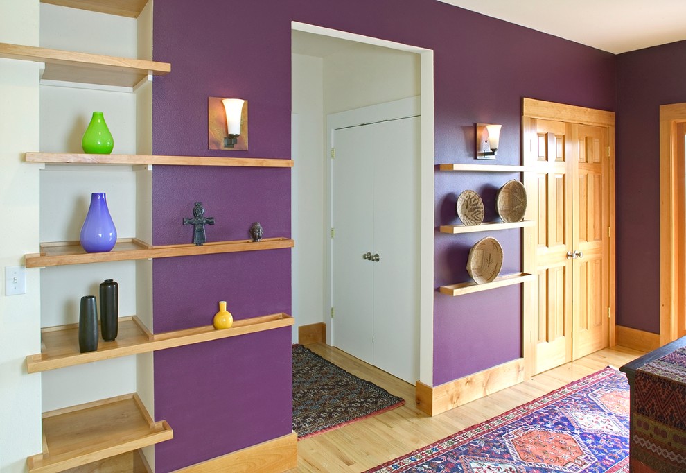 Hallway - mid-sized contemporary medium tone wood floor hallway idea in Denver with purple walls