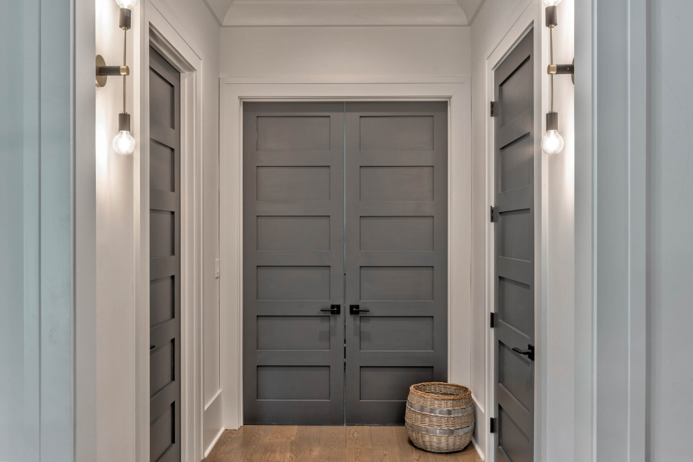 Hallway - mid-sized modern medium tone wood floor and brown floor hallway idea in Atlanta with white walls