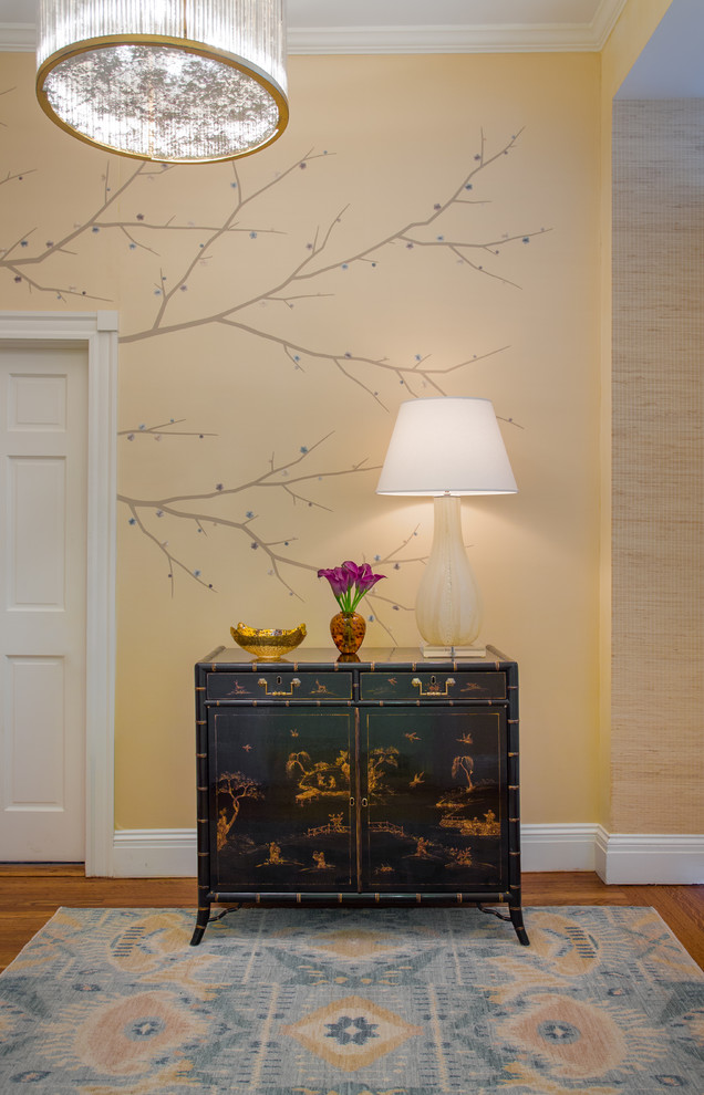 Example of a mid-sized asian medium tone wood floor hallway design in Boston with beige walls