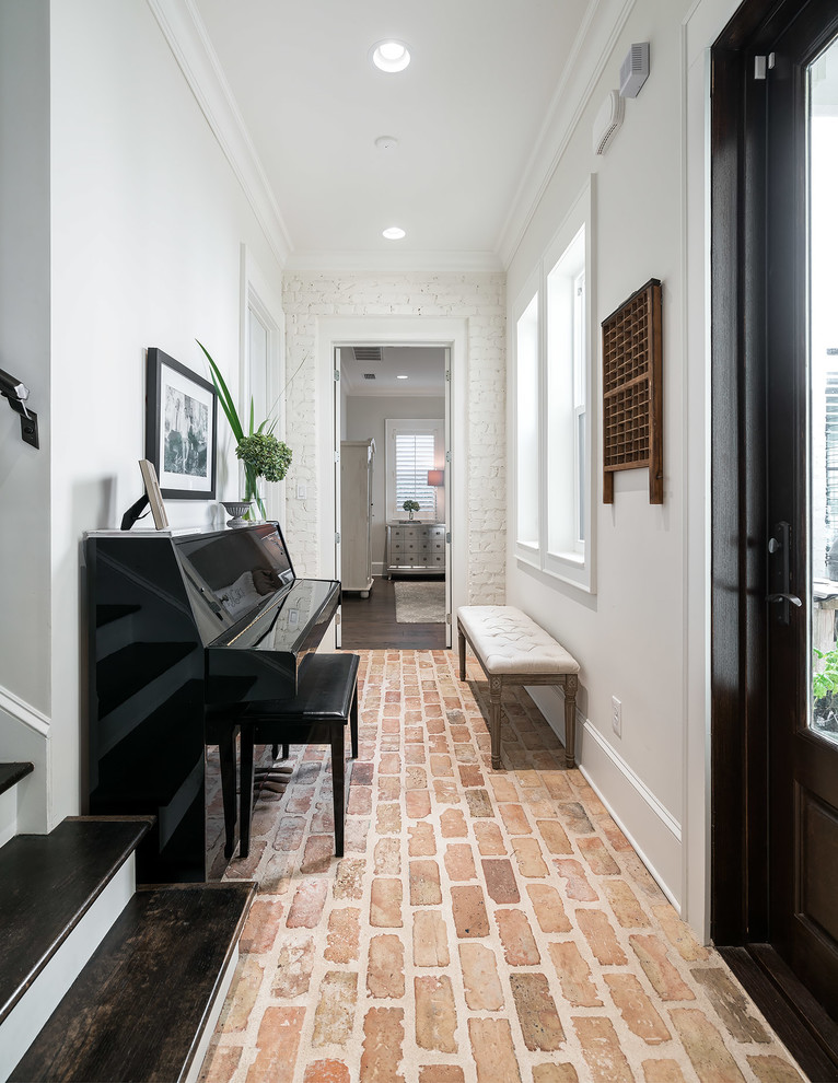 Idee per un ingresso o corridoio tradizionale con pareti bianche, pavimento in mattoni e pavimento rosso
