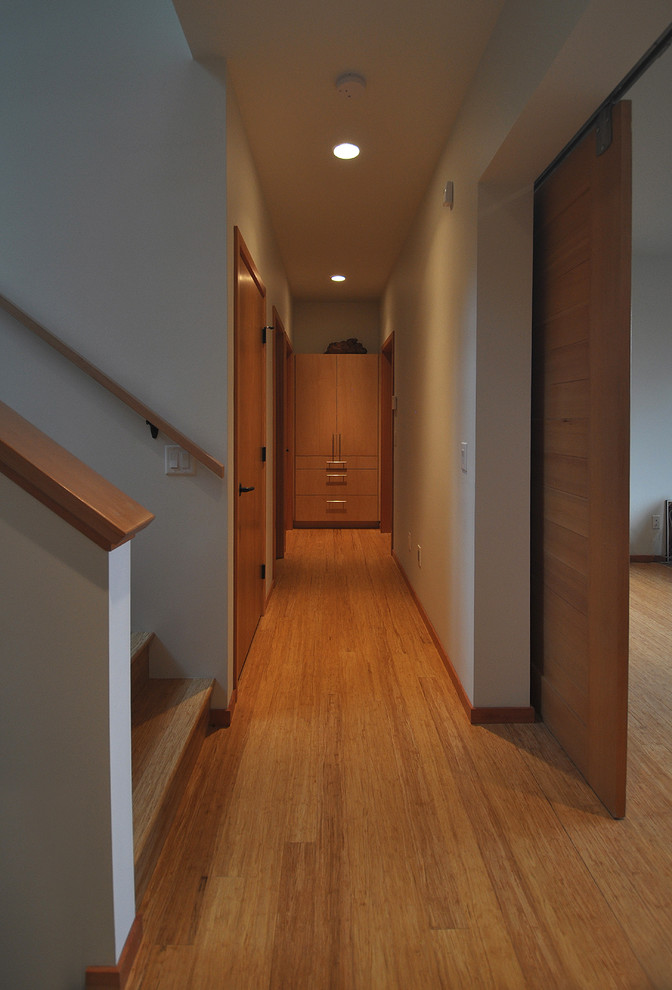 Idee per un ingresso o corridoio contemporaneo di medie dimensioni con pareti bianche e pavimento in bambù