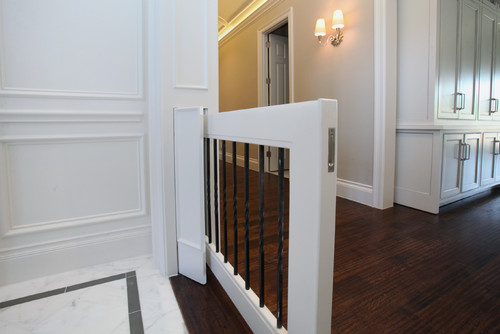 Built-in gate with white frame and black railing. 