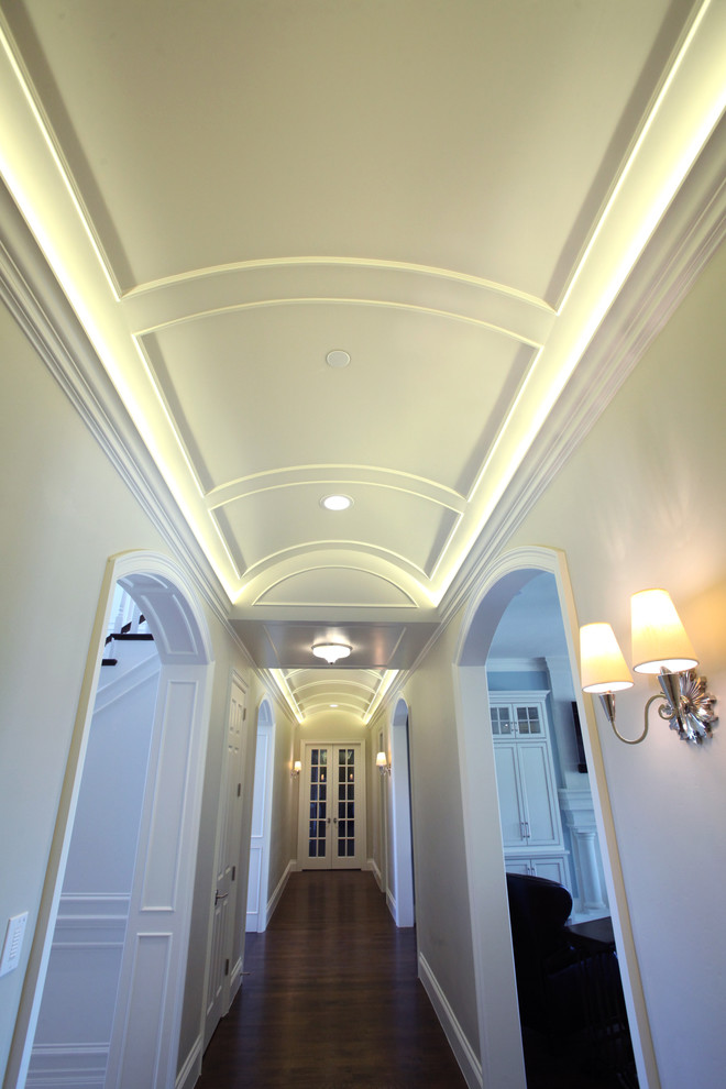 Example of a mid-sized classic dark wood floor and brown floor hallway design in Dallas with white walls